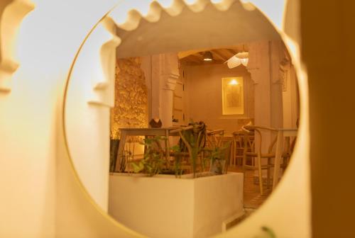 a mirror reflecting a room with a table and chairs at Riad Nila in Chefchaouene
