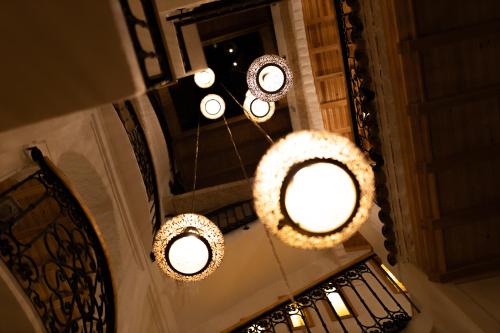 an overhead view of two chandeliers in a building at Riad Nila in Chefchaouene