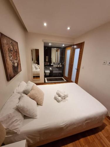 a bedroom with a large white bed with a mirror at House of Zoo in Lisbon