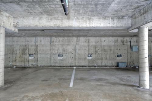 an empty parking garage with concrete walls and columns at La Costa Escape - Pool, BBQ, Gated Parking in Encinitas