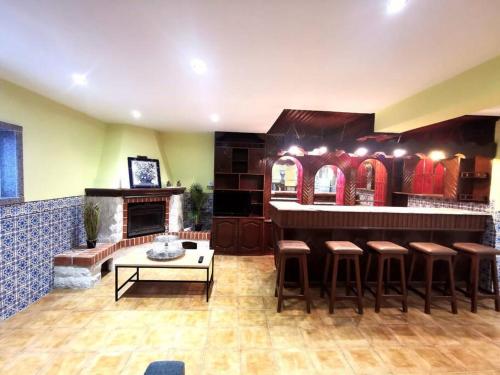 a restaurant with a bar with stools and a fireplace at Nina23 - garagem gratuita in Aveiro