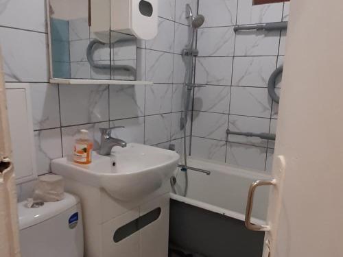 a bathroom with a sink and a toilet and a shower at Квартира возле парка Б. Хмельницкого (центр) из первых рук in Chernihiv