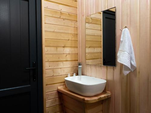 a bathroom with a white sink and a mirror at Focus Point Drakhtik - Rose Cabin in Drakhtik