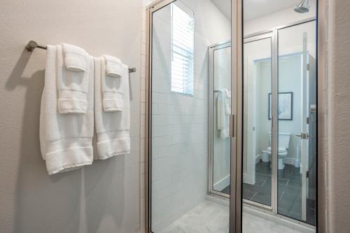 a bathroom with a shower and a mirror at Entire 6 Bedroom Triplex Home in Austin in Austin