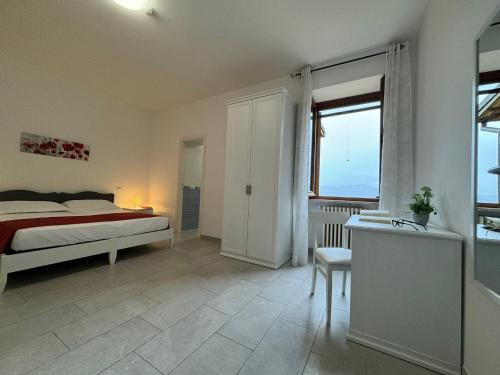 a bedroom with a bed and a large window at Monastero SS. Annunziata in Todi