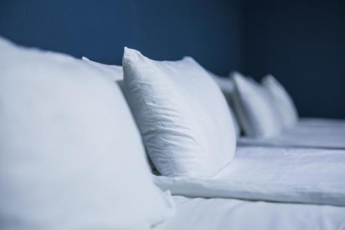 a row of white pillows on a bed at Golden Palace Hotel in Tbilisi City