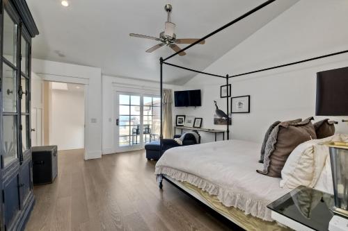 a bedroom with a bed and a ceiling fan at Luxury Ocean Views - 6 BR Home - Steps to Sand in Carlsbad