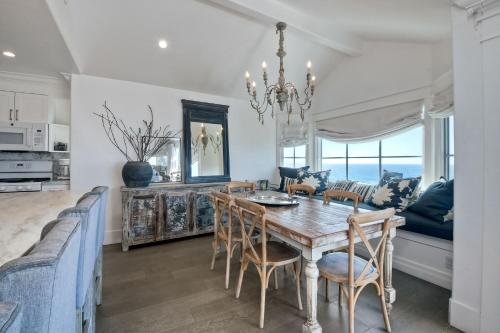 a dining room with a table and chairs at Luxury Ocean Views - 6 BR Home - Steps to Sand in Carlsbad