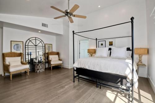 a bedroom with a bed and a ceiling fan at Luxury Ocean Views - 6 BR Home - Steps to Sand in Carlsbad