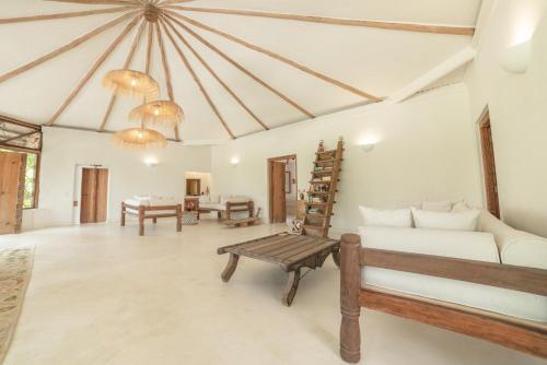 a living room with a couch and a table at Bamboo House B&B in Malindi