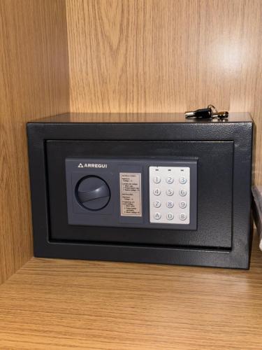 a black microwave sitting on top of a table at San Blas Golf del Sur Residence in San Miguel de Abona