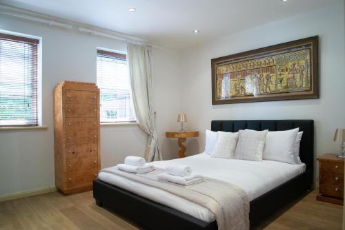 a bedroom with a bed with two towels on it at Super Central beautiful 3 Bedroom in London