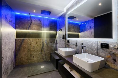 a bathroom with two sinks and a shower at Hotel Metropolitan in Bologna