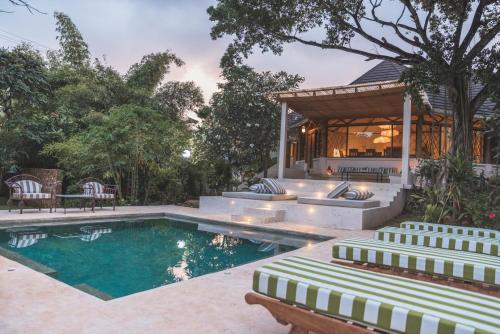 een huis met een zwembad en een prieel bij Bamboo House B&B in Malindi