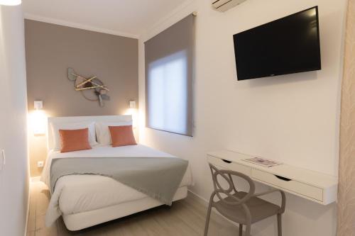 Ένα ή περισσότερα κρεβάτια σε δωμάτιο στο Faro Guest Apartments