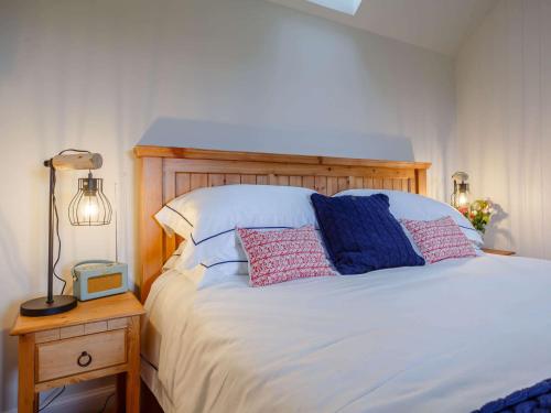 a bedroom with a white bed with a wooden headboard at 1 Bed in Alness 83888 in Alness