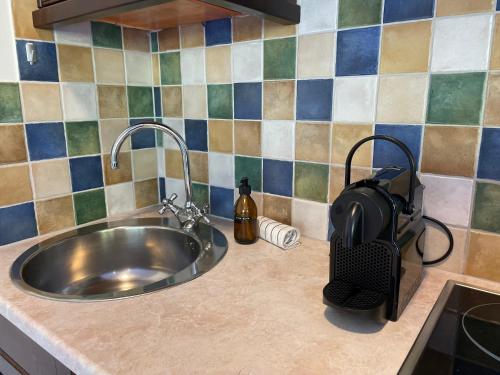 a stainless steel sink in a kitchen with tiles at International House Sölden Studio mit Balkon ZW 2 in Sölden