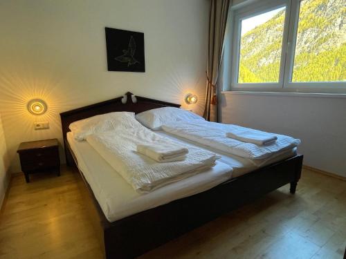 1 dormitorio con 1 cama con toallas en International House Sölden Apartment mit Balkon ZW 12, en Sölden