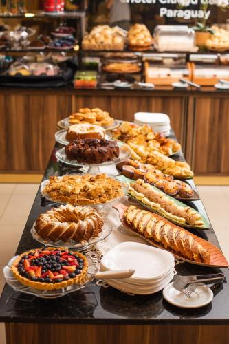 a table with many different types of food on it at Howard Johnson Ciudad del Este in Ciudad del Este