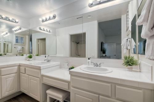 a bathroom with two sinks and a large mirror at Lagoon Views - Pool - Hot Tub - Gated Community in Carlsbad