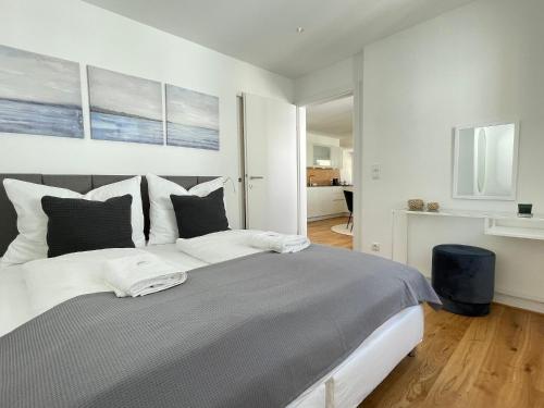 a bedroom with a large bed with two pillows at VINCENT Apartment in Bregenz mit Parkplatz in Bregenz