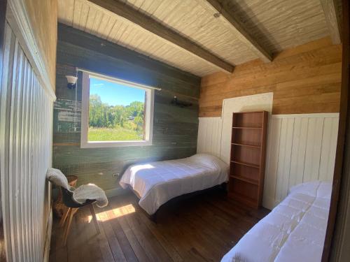 Ένα ή περισσότερα κρεβάτια σε δωμάτιο στο Hacienda Totoral - Frutillar