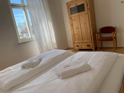a bedroom with two white beds and a window at Studio im Zentrum von Lochau, #5 in Lochau