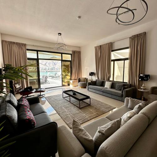 a living room with a couch and a table at Al Dana Sea View Villa in Fujairah