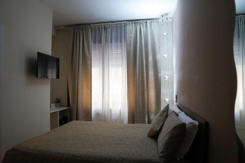 a hotel room with a bed and a window at SalernoPrestige rooms in Salerno