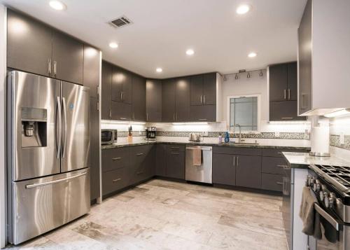 a kitchen with stainless steel appliances and gray cabinets at Private Room0 Own Bath Own Entry Shared Kitchen Walk to UCSD in San Diego