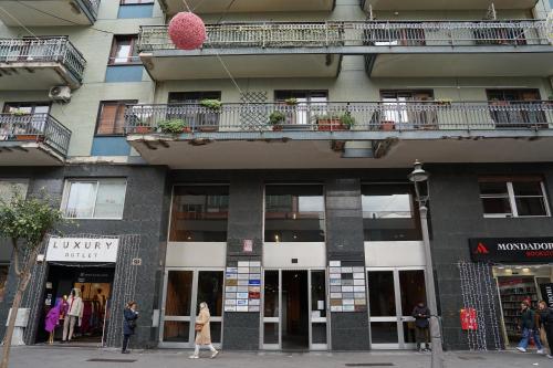 a building with people walking in front of it at SalernoPrestige rooms in Salerno