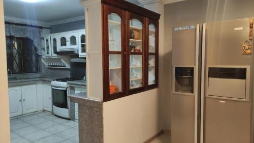 a kitchen with white cabinets and a refrigerator at Casa Cuenca in Cuenca