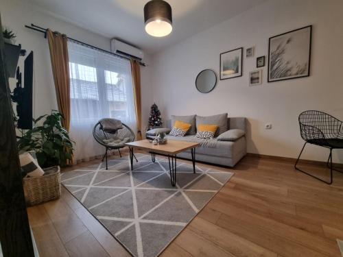 a living room with a couch and a table at Apartment 12-09 in Bajina Bašta