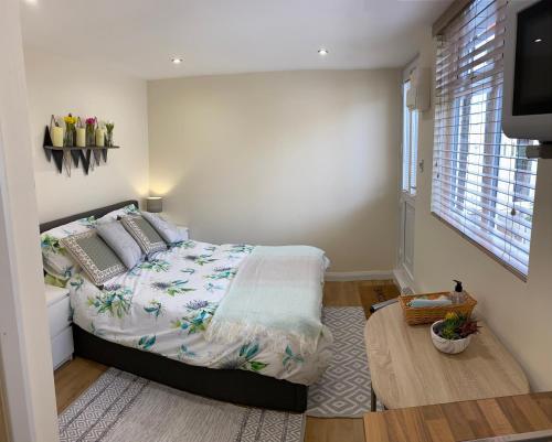 a bedroom with a bed and a flat screen tv at Self-Contained Double-bed Studio in Central Sherwood in Nottingham