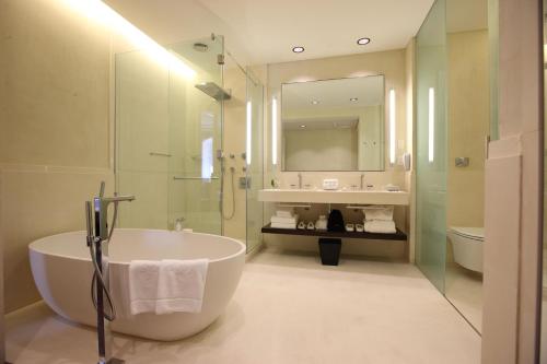 a bathroom with a tub and a sink and a mirror at Algodon Mansion in Buenos Aires