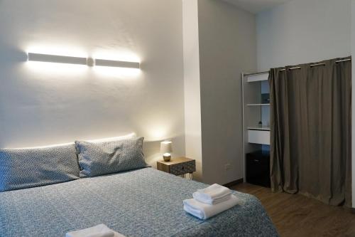 a bedroom with a bed with two towels on it at SalernoPrestige rooms in Salerno