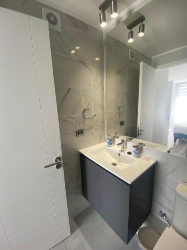 a bathroom with a sink and a mirror at Depto nuevo en brisas del sol in Talcahuano