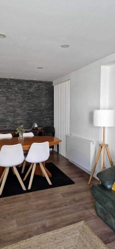 a living room with a table and white chairs at Apartamento T3 - férias in Barcelos