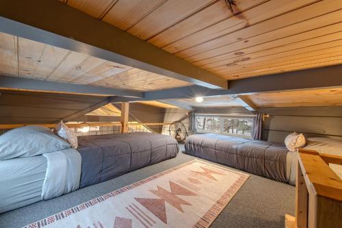 two beds in a room with wooden ceilings at Gabriele Cabin Rustic Retreat Near Downtown in Chattanooga