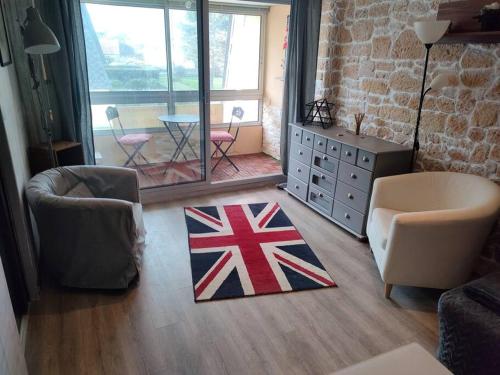 sala de estar con alfombra de bandera en el suelo en bienvenue chez vous, en Bernières-sur-Mer