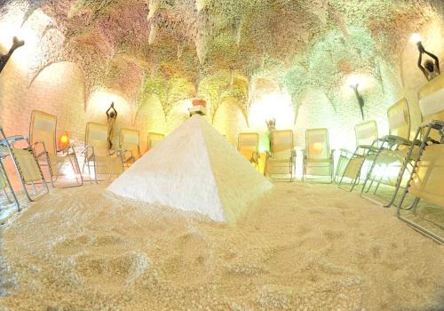 a large white pyramid in a room with chairs at Ośrodek Uzdrowiskowy Malwa in Ustroń