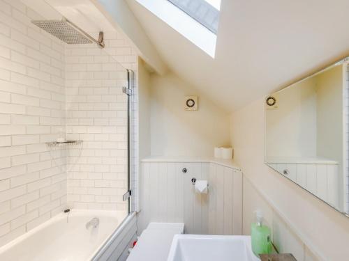 a bathroom with a bath tub and a sink at 2 Bed in Betws-y-Coed SKN03 in Yspytty-Ifan