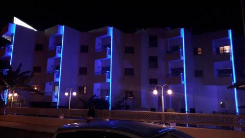 a car parked in front of a building at night at Boronia Hotel Apartments in Larnaka