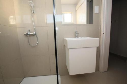 a bathroom with a shower and a sink and a shower at Boronia Hotel Apartments in Larnaka