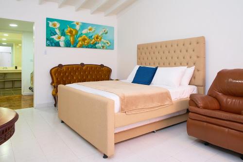 um quarto com uma cama e uma cadeira em Apartahotel Fiorentina Boutique em Medellín