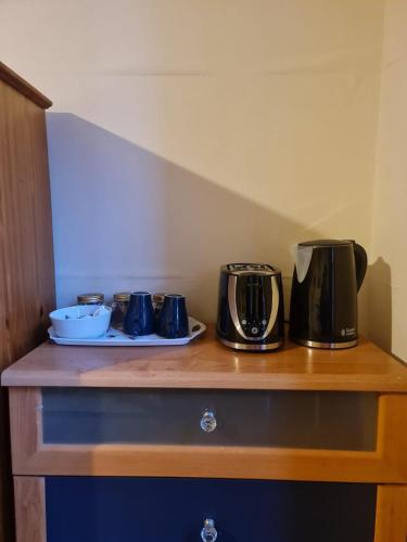 a counter with two coffee makers on top of it at Cathcart Place Rooms in Edinburgh