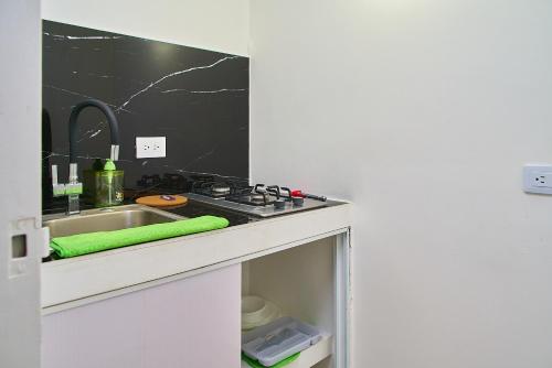 a kitchen counter with a sink and a stove at Hotel Boutique Fiorentina Medellín in Medellín