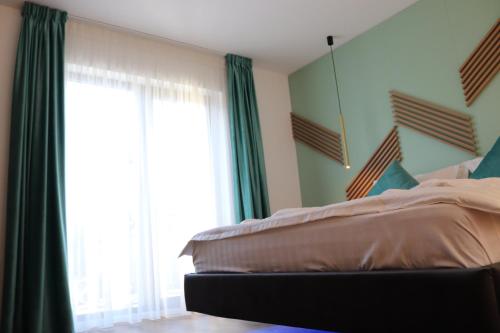 a bedroom with a bed and a large window at White House Moieciu in Moieciu de Jos