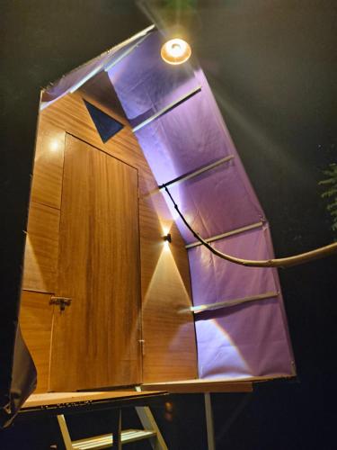 a room with a wooden door with a light on it at Tentrwoody in Ramakkalmedu