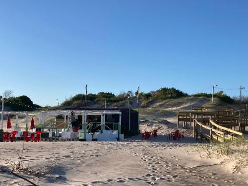 a beach with a stage on the sand at Mar 11 a 100 mtros del mar in Parque del Plata